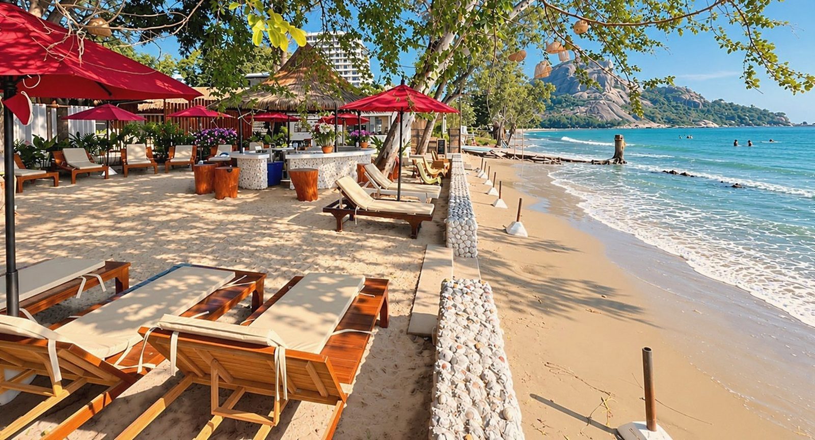 Loungers along the shore with Khao Takiab hill